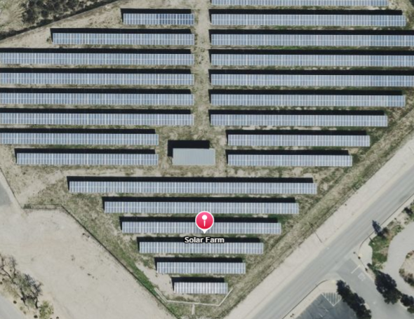 Aerial view of the CSUSB solar farm featuring rows of photovoltaic panels generating renewable energy.