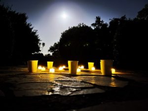 candel in field under moon light