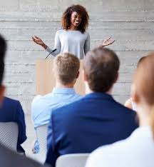 A woman giving a speech to an audience