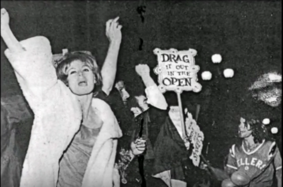 Drag queen with fist up screaming and chanting