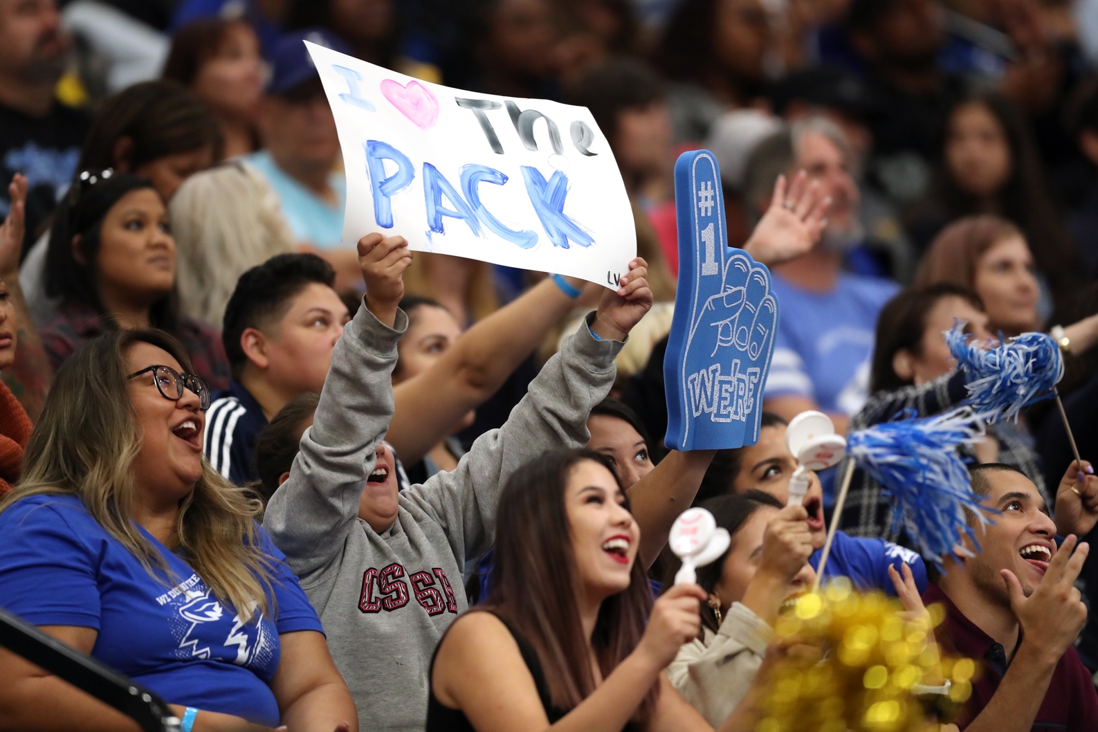 Student holding a "I love the Pack" sign.