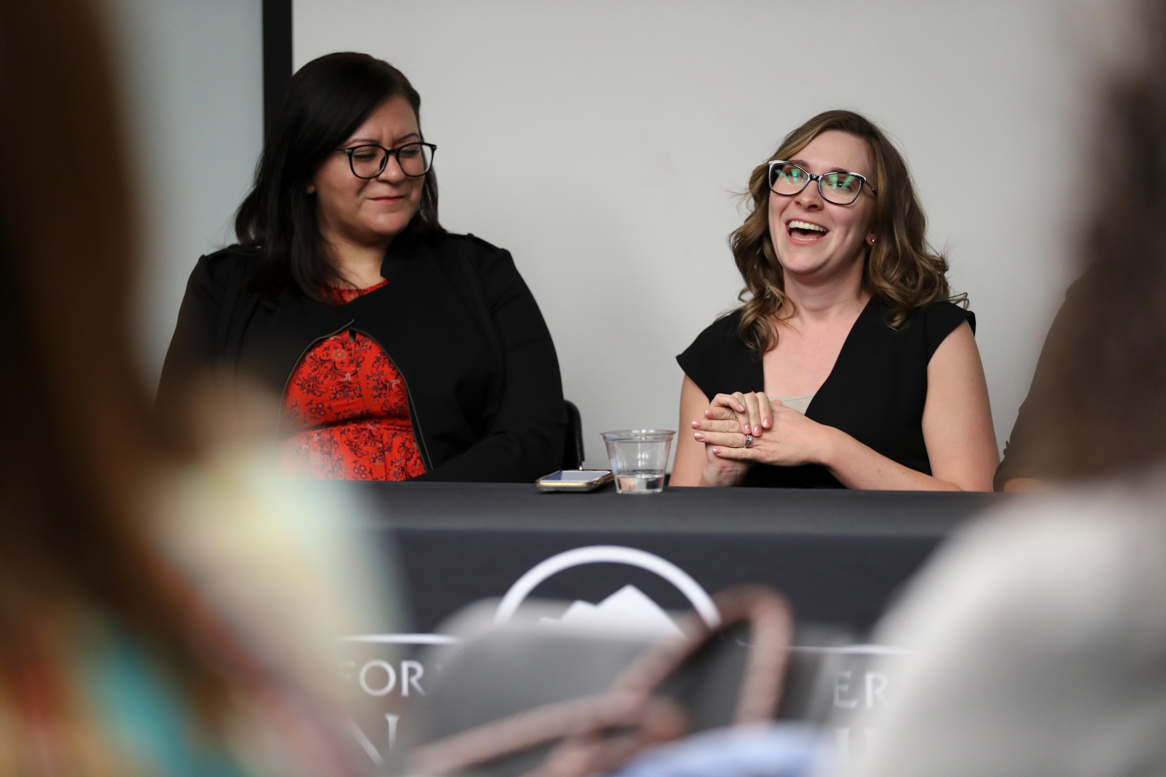 Students talking on a panel to audience.