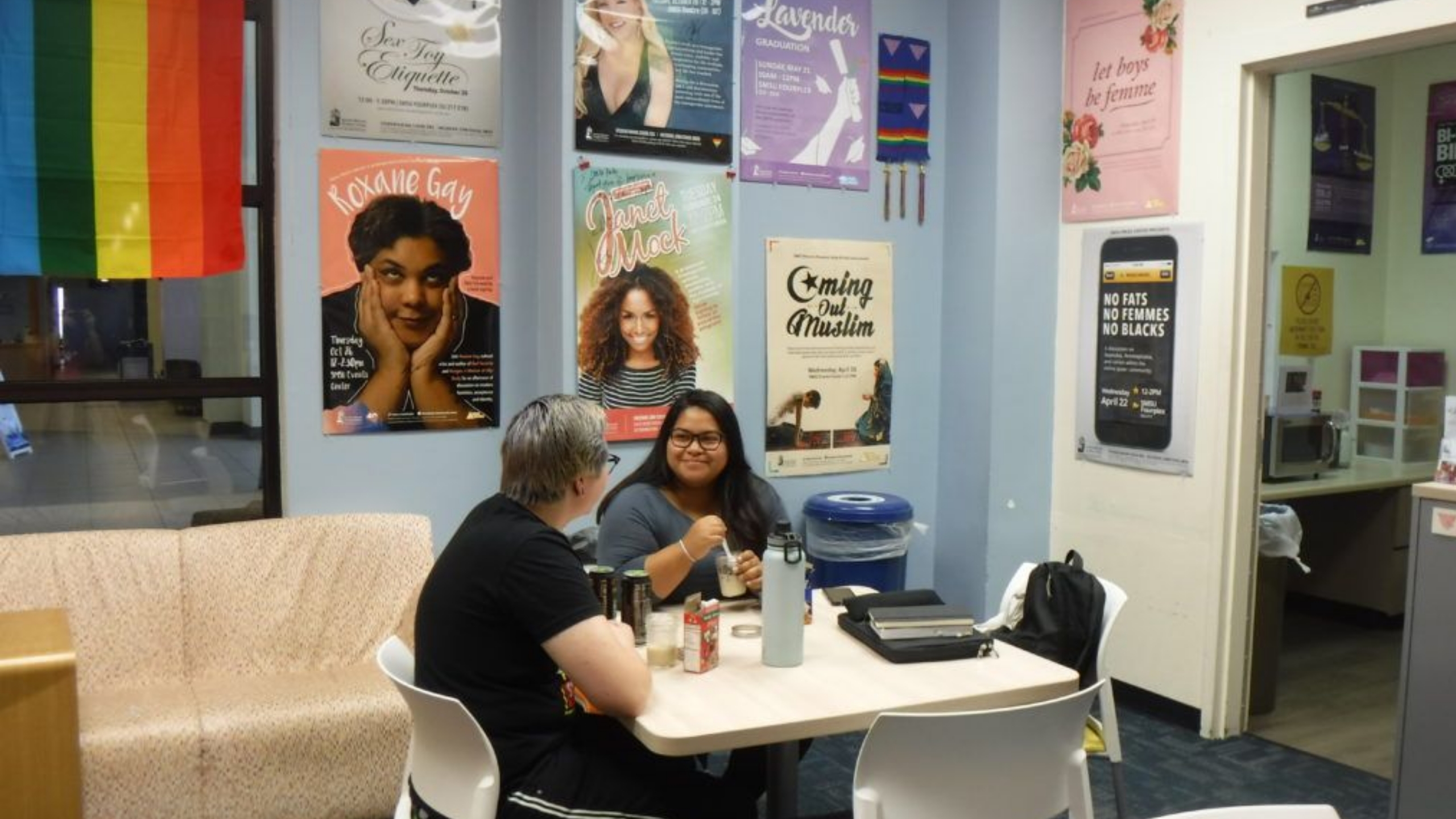 student and faculty talking in the center