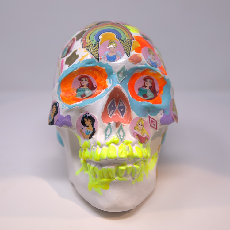 White skull with neon colors and images of Disney Princesses.