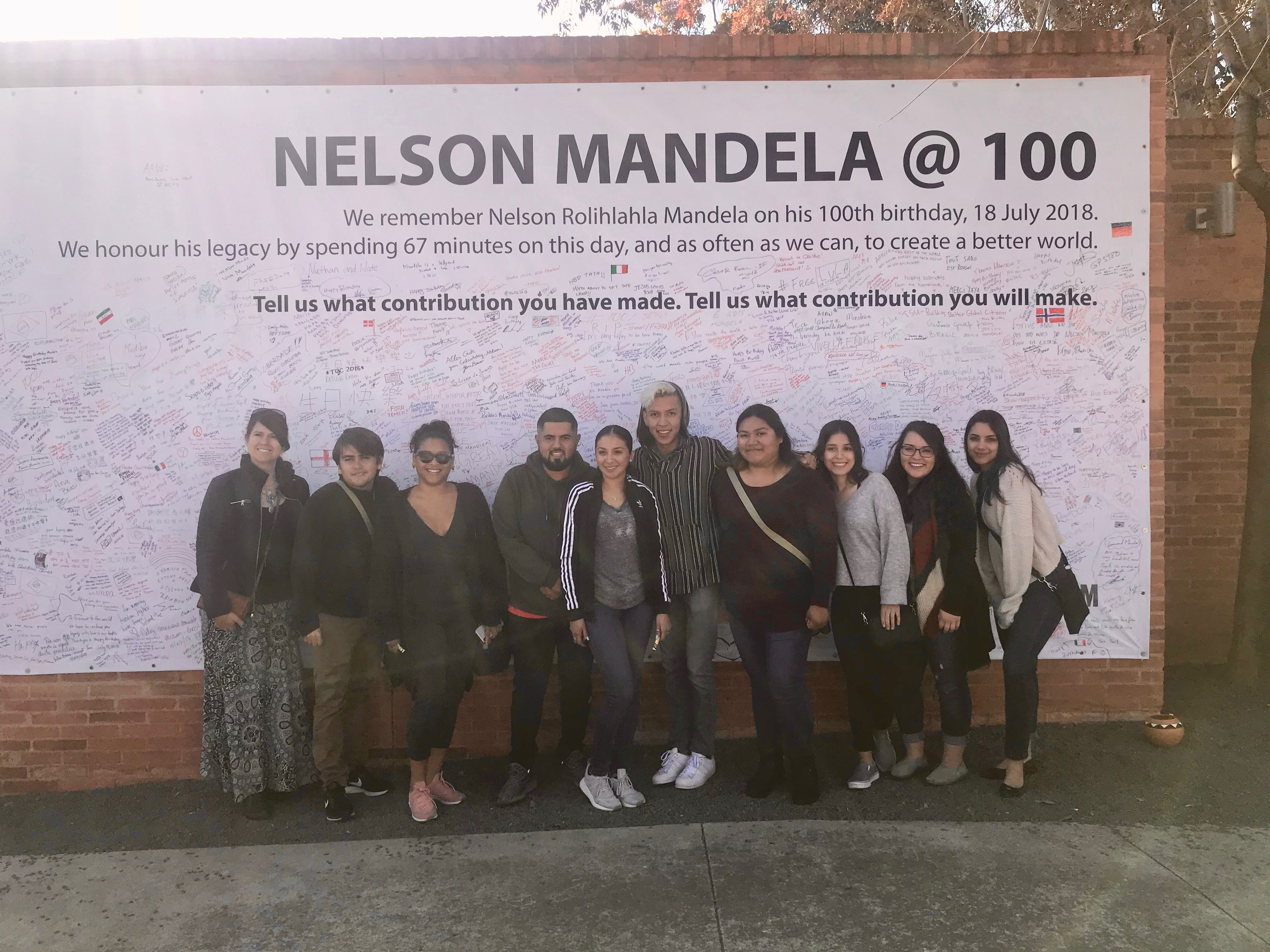 CSUSB Students in Front of Nelson Mandela @100 Banner