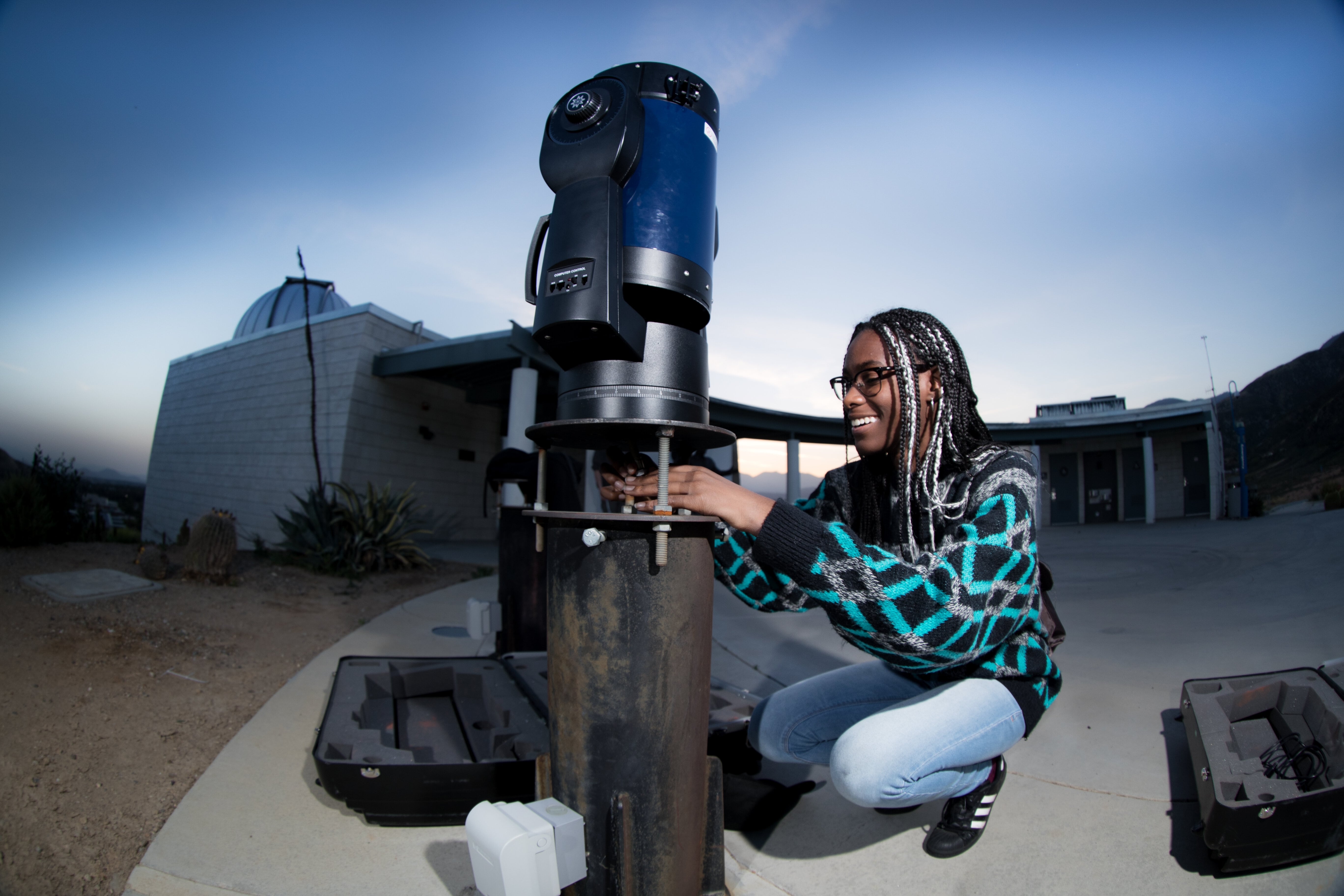 Student interacting with telescope