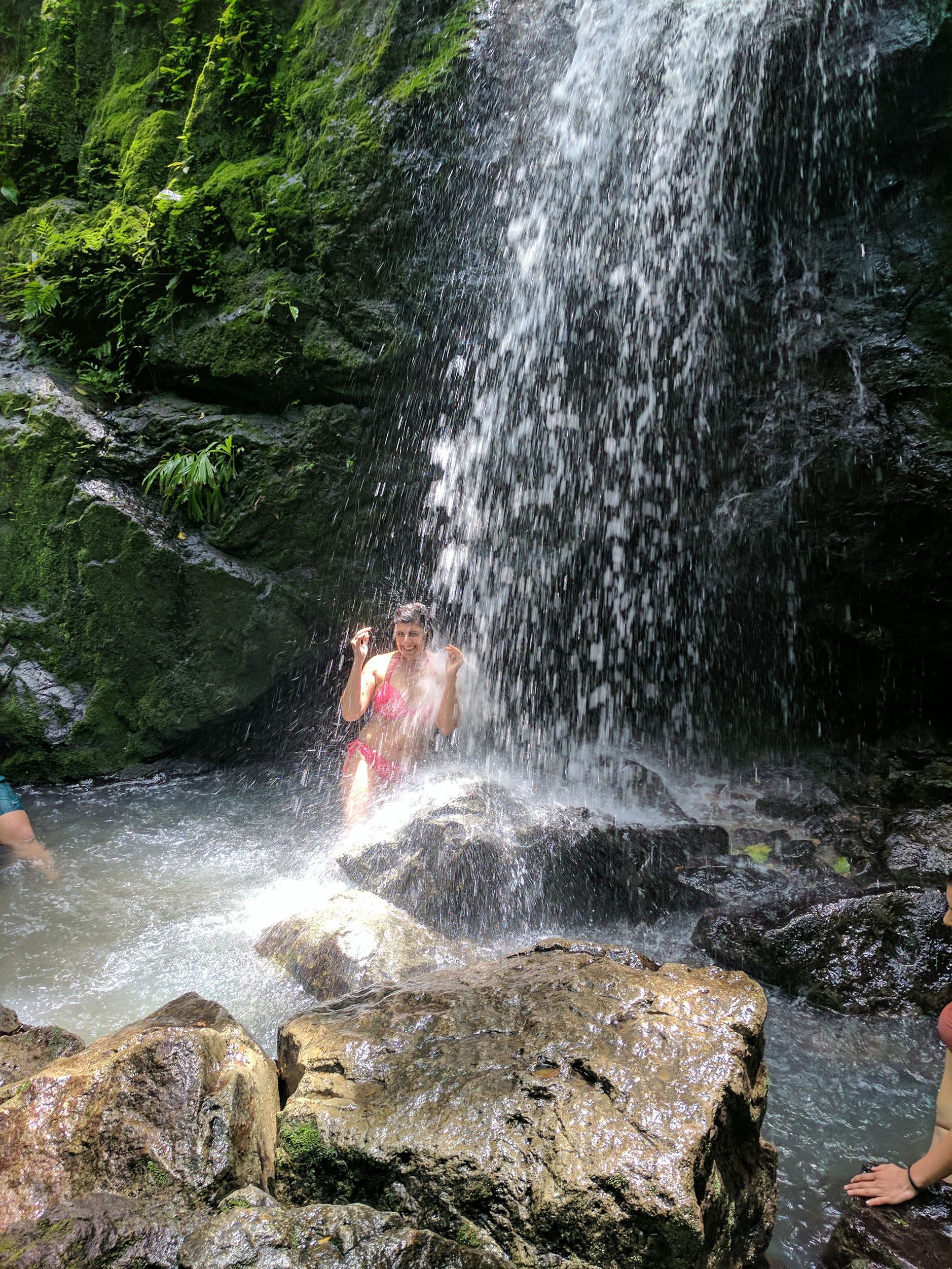 Student under waterfall in Costa Rica