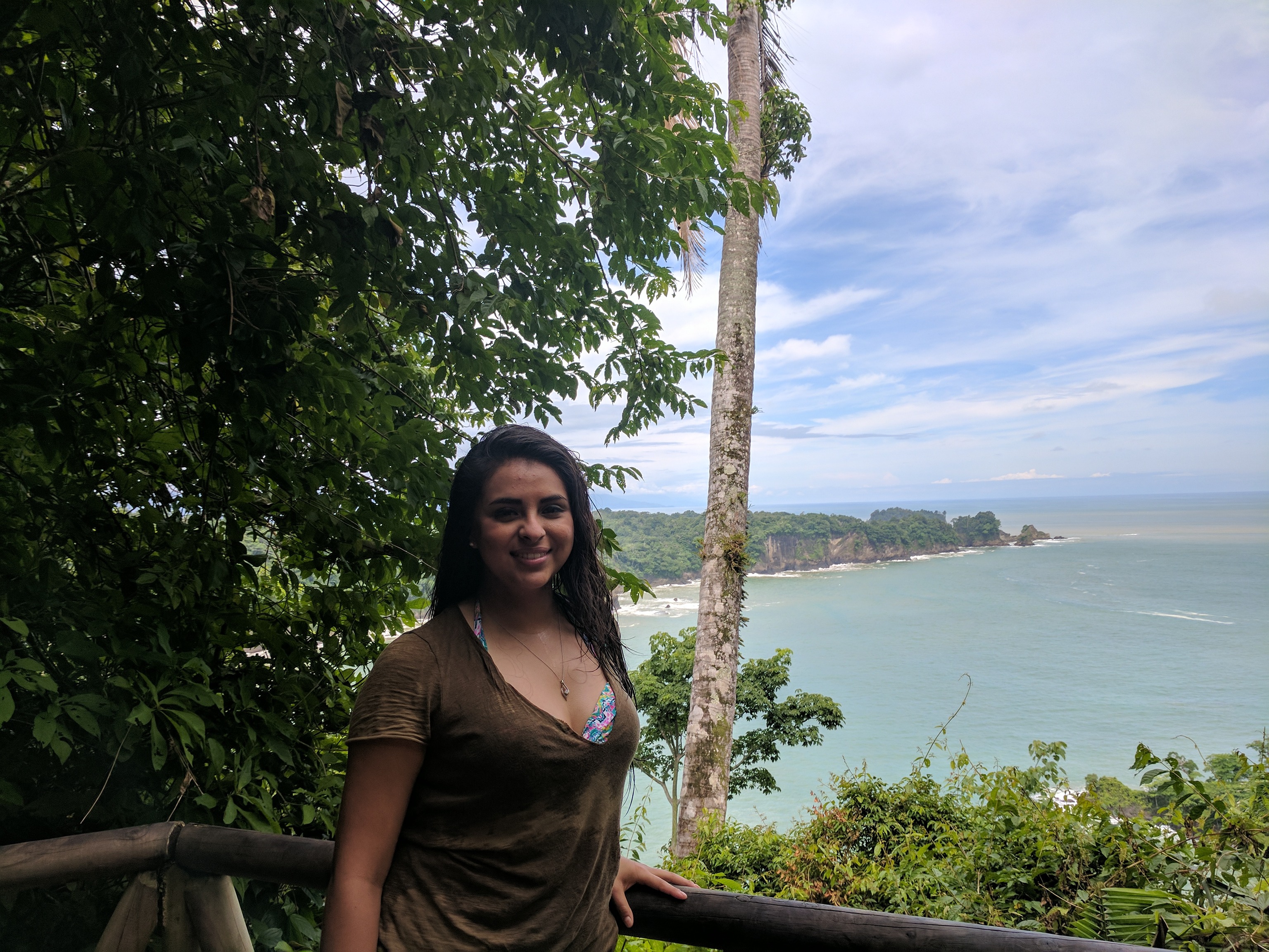 Student in front of cliffs and water