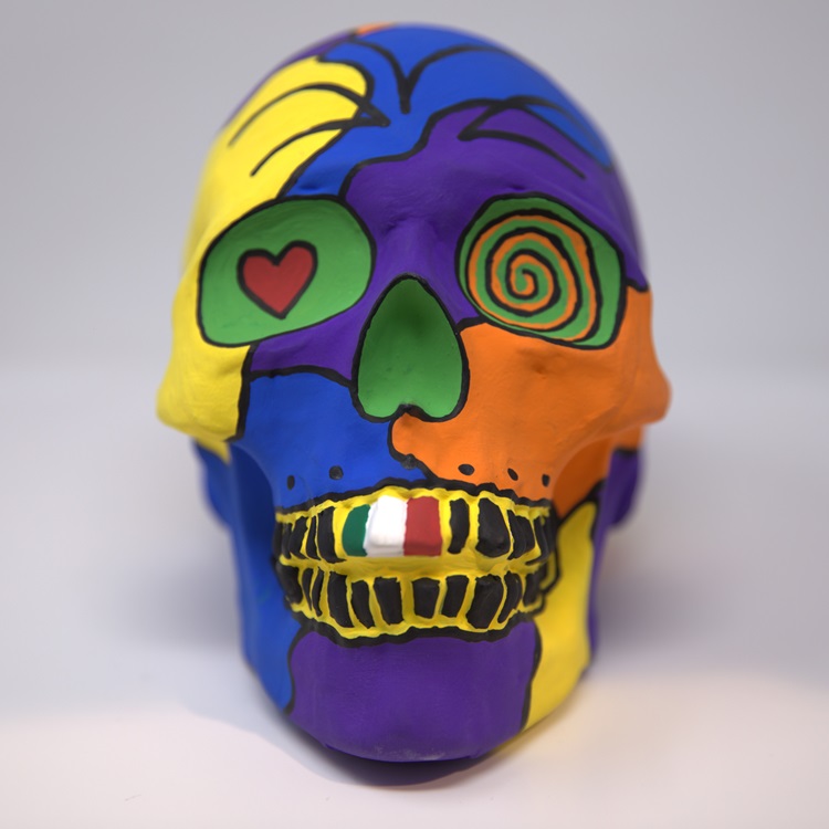 Colorful calavera with details in black featuring a Mexican flag.
