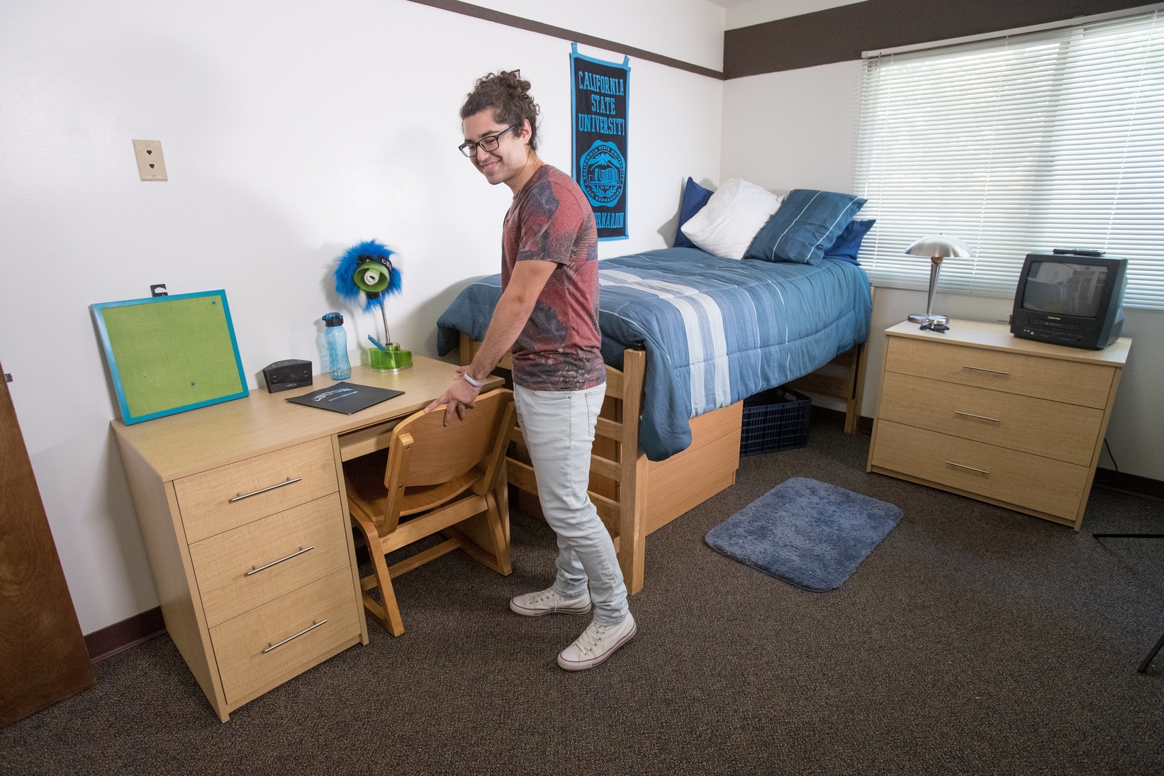 Student showing his bedroom