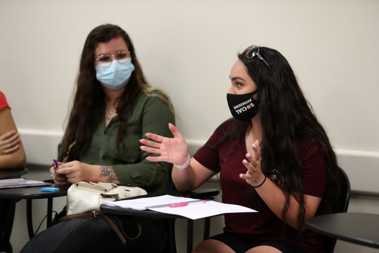 Couple of students talking in the classroom