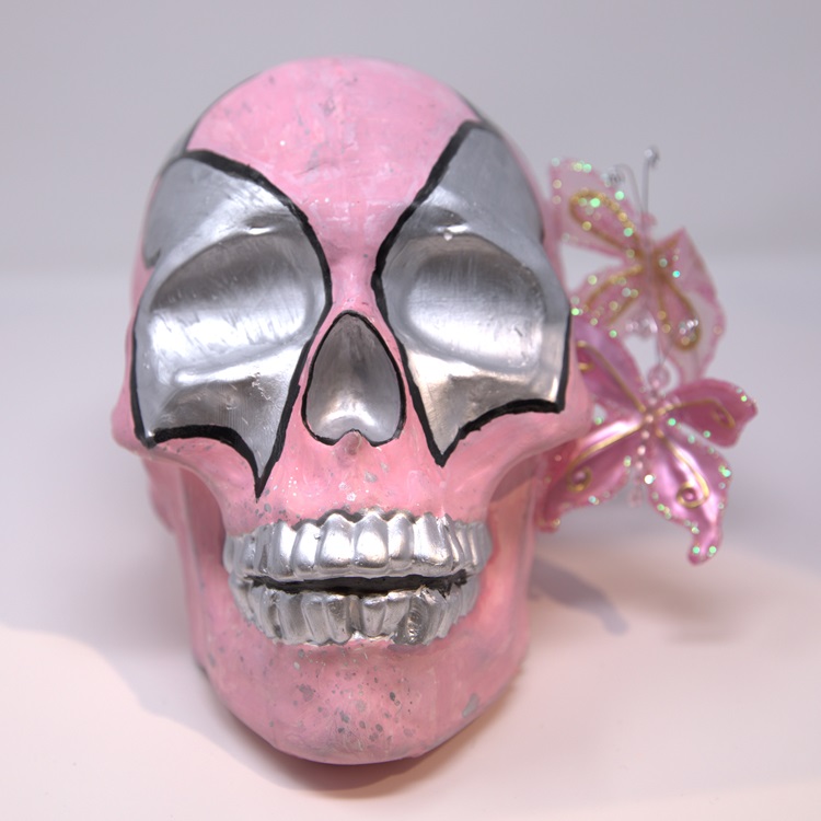 Pink painted skull silver details in the form of a luchador mask flower details