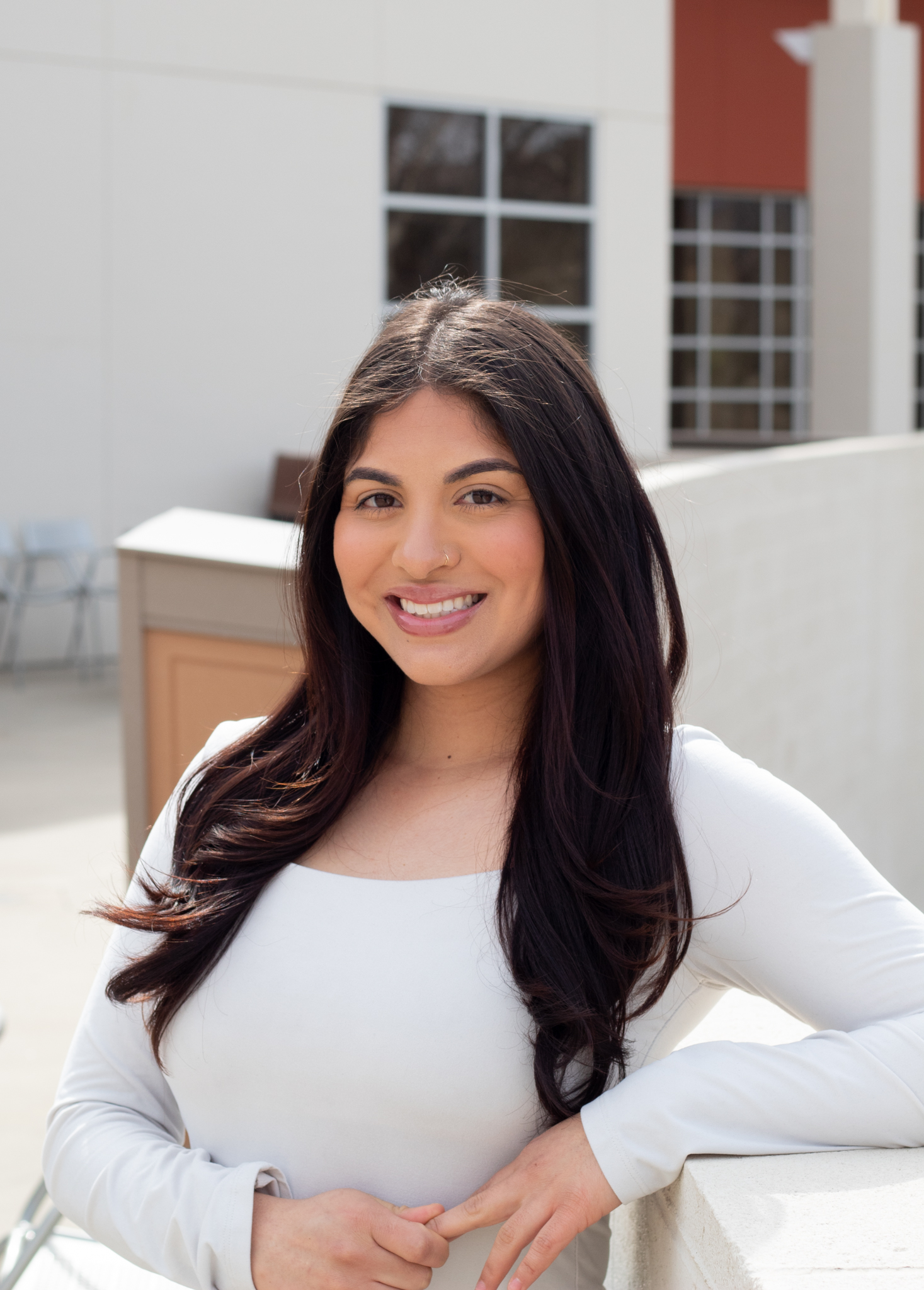 Educational Counselor Priscilla Zamora wearing a white blouses.