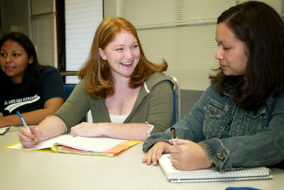 Several students in a classroom collaborating amongst each other