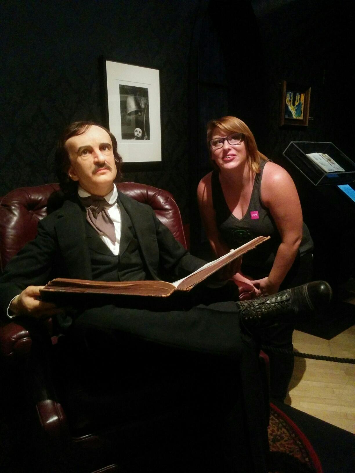 Professor Zarate posing with a statue of Edgar Allan Poe
