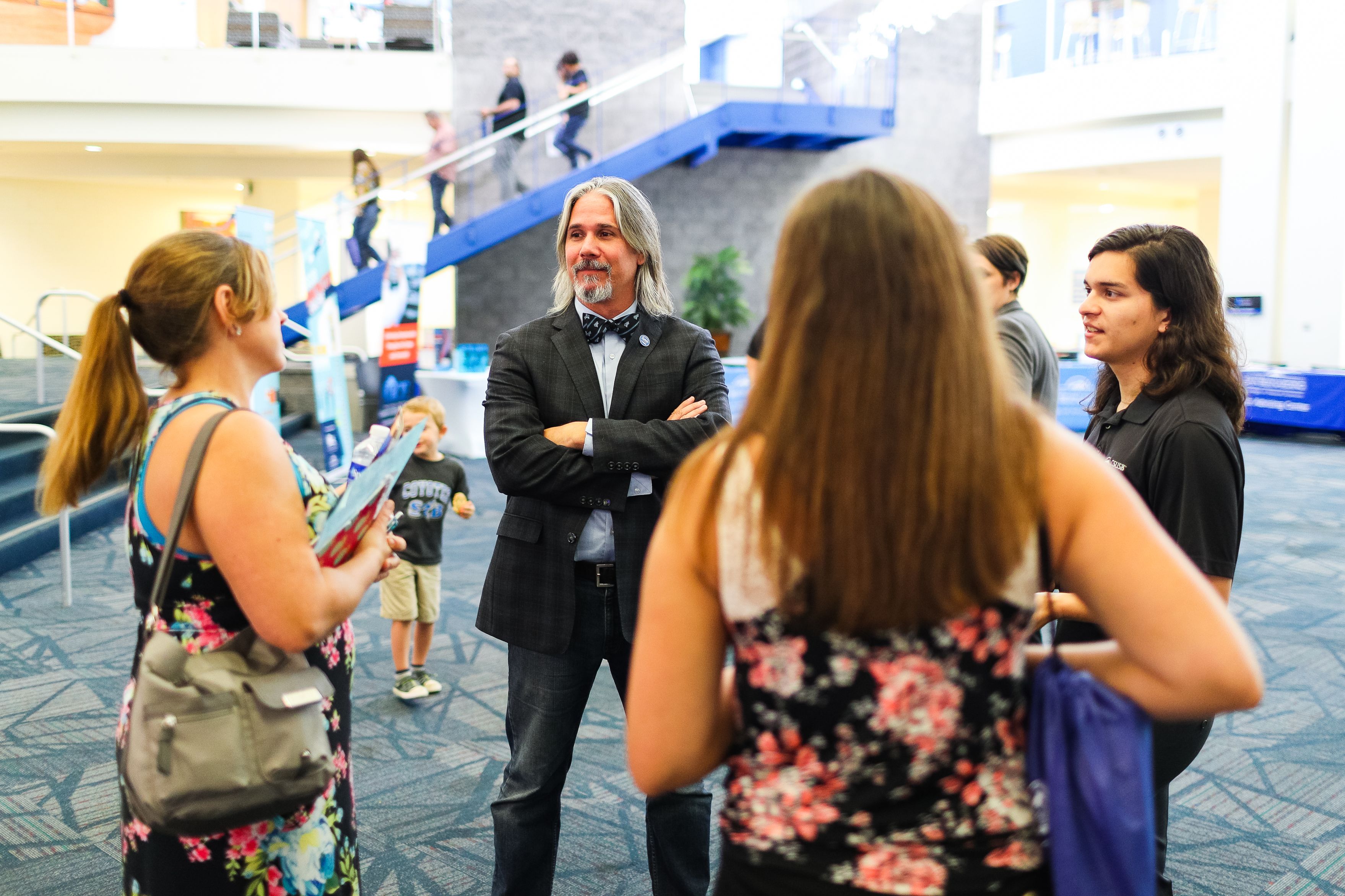 Professor talking with prospective student and family