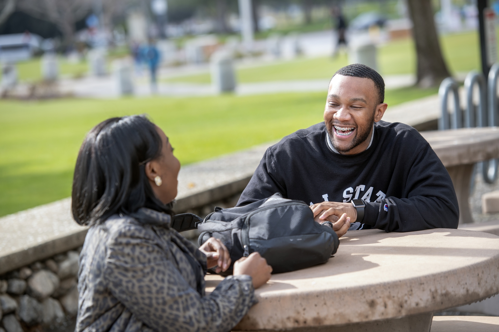 Students talking and laughing at a table.