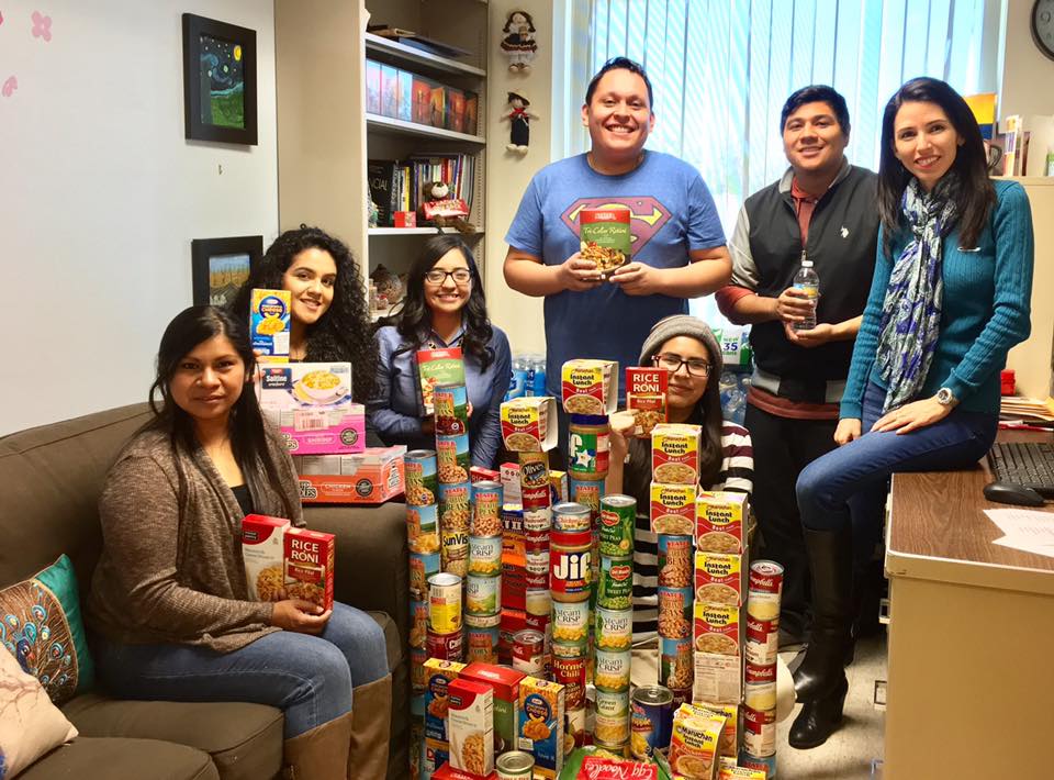 Club students in front of stacks of donated food