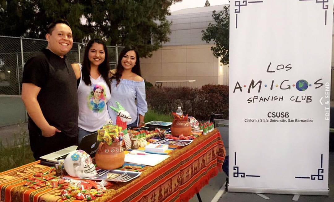 Club members at table with candy and cultural decor