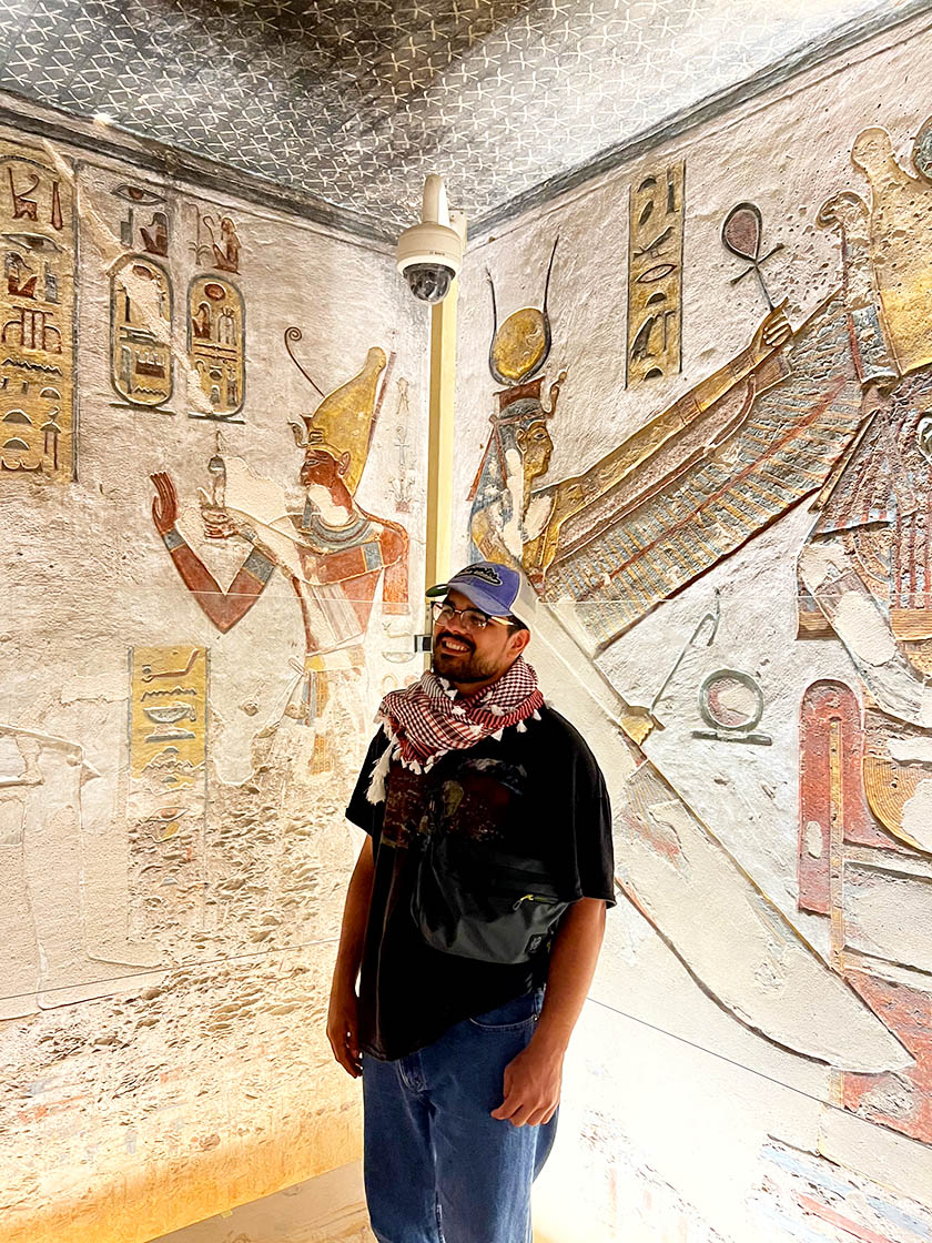 Nathaniel Saavedra among walls of hieroglyphics.