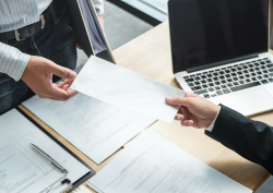 Employee handing supervisor paperwork