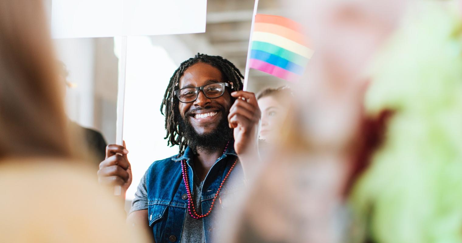 Student waving pride flag.