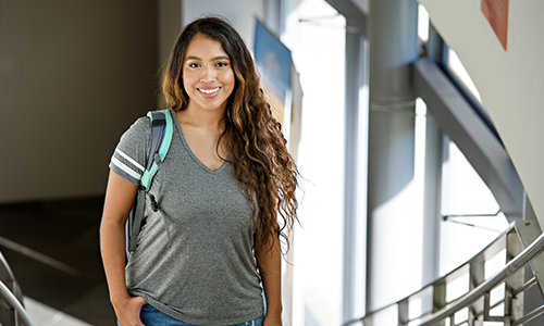 Female student standing in building