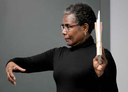Lady gesturing to folder