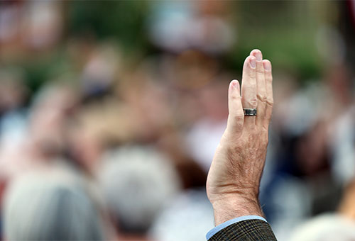Elderly student raising their hand