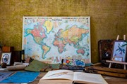 Picture of map, open book and assorted research materials