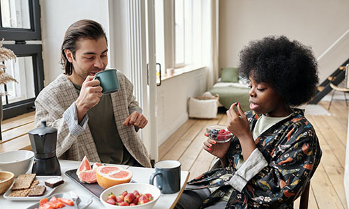 Two people eating breakfast.