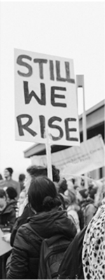 Protestor holding a Still We Rise sign