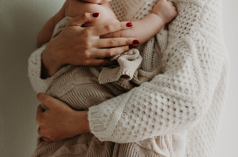 Mother's arms holding baby