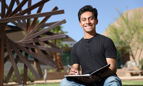 Student outside with lap top