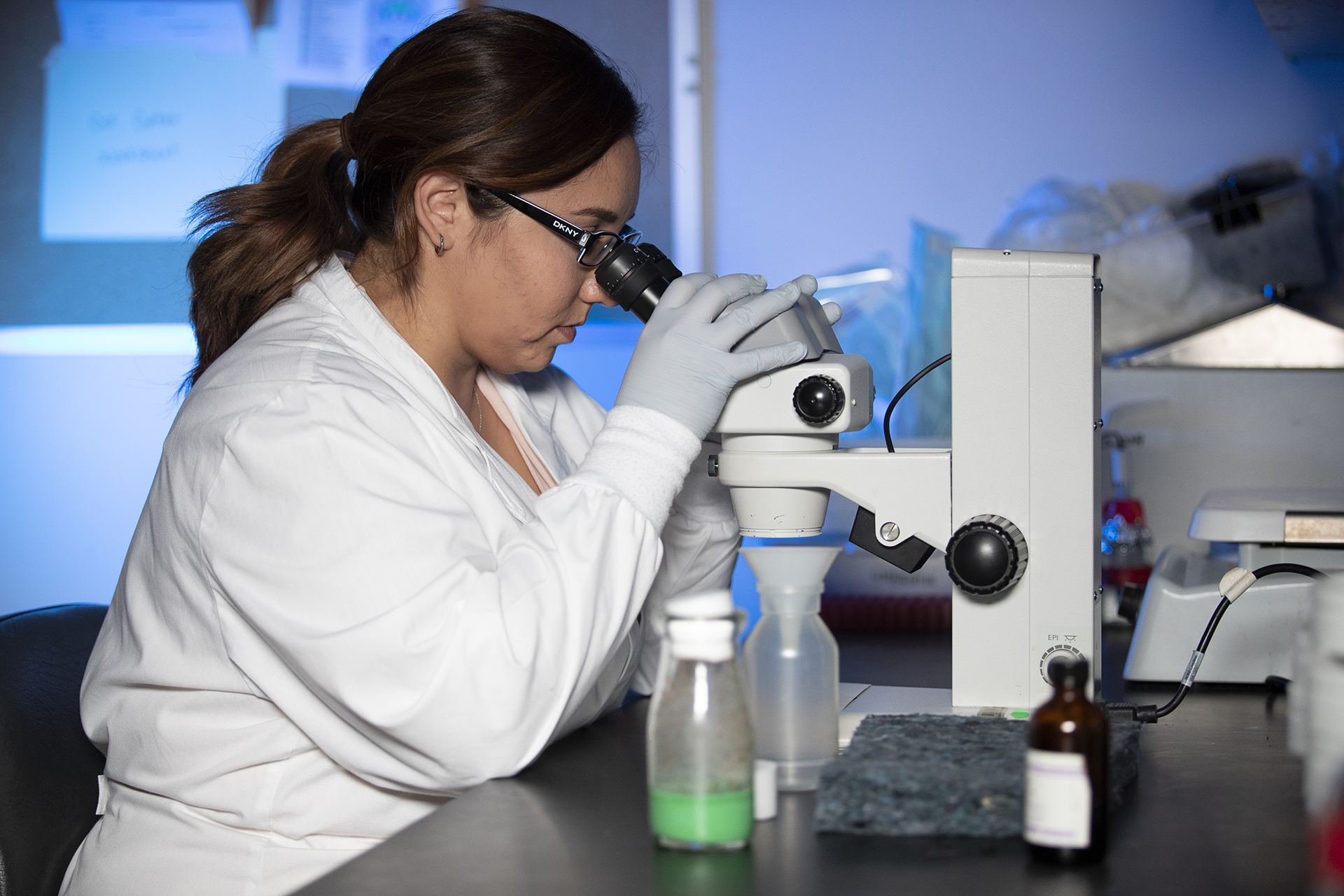 Student looking through microscope